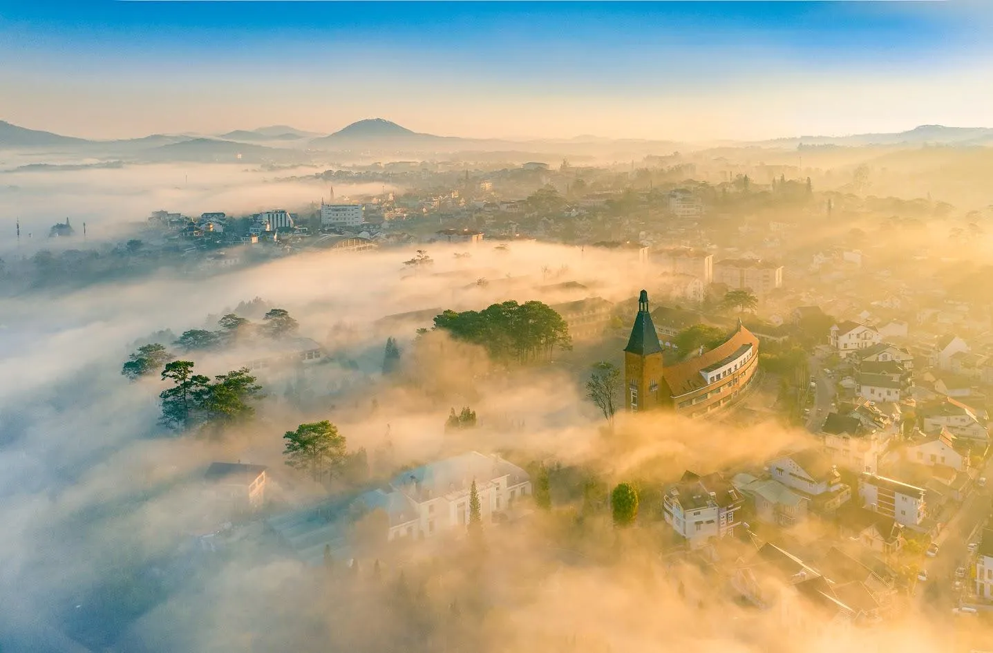 Morning mist over Da Lat with the cathedral spire
